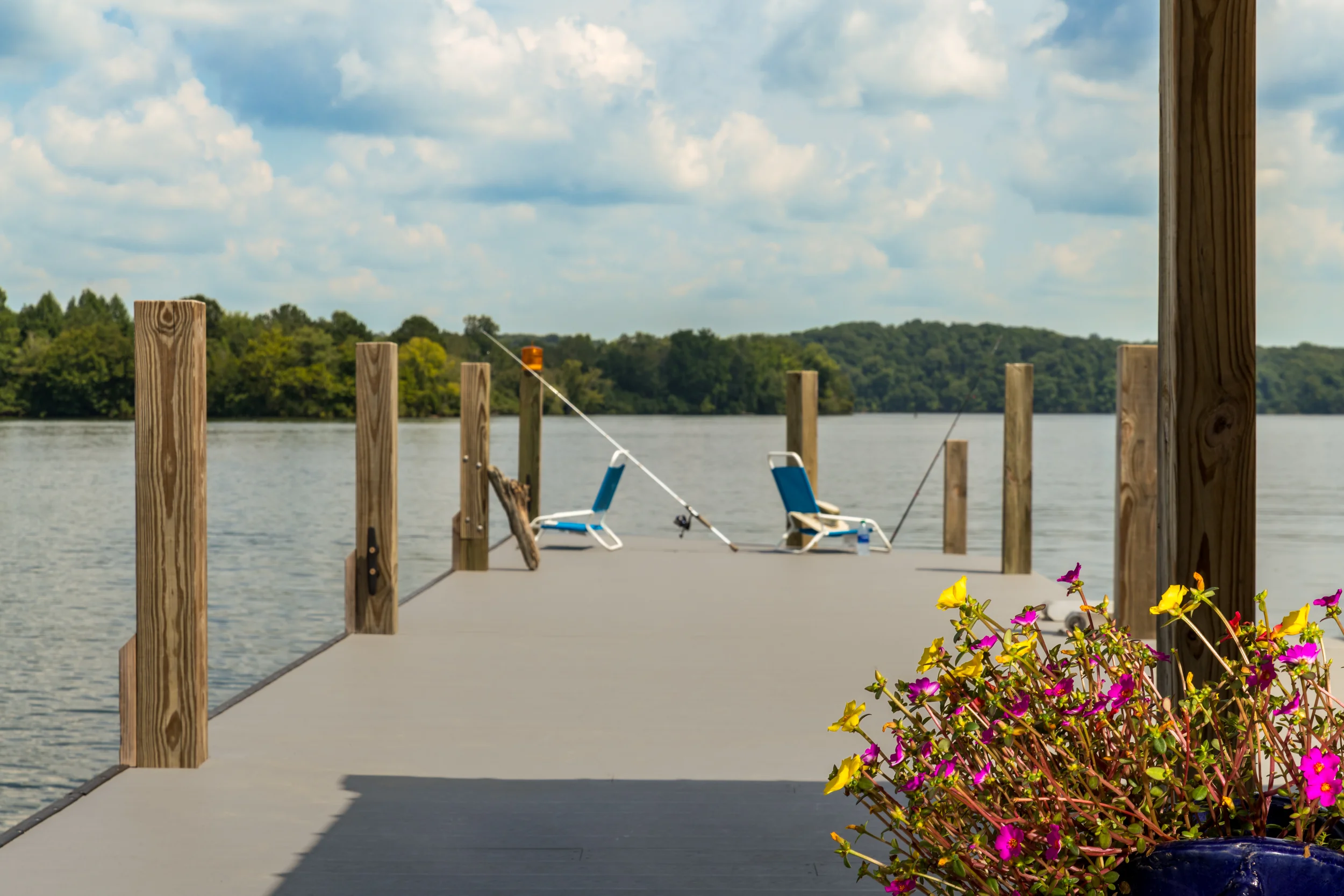 Chairs, american flags, fishing poles and swimming gear on a dock in Soddy Daisy, Tennessee.