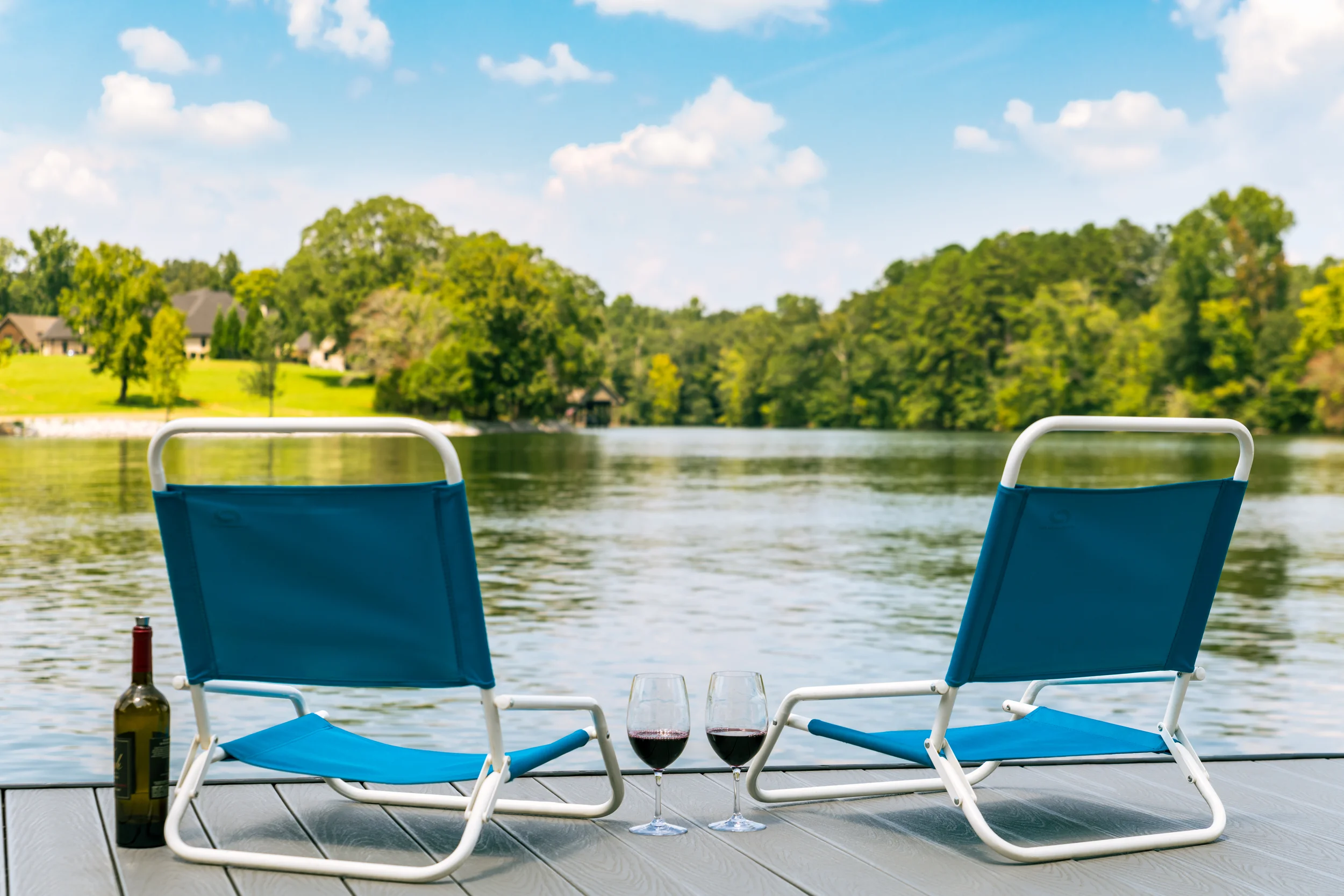 Chairs, american flags, fishing poles and swimming gear on a dock in Soddy Daisy, Tennessee.
